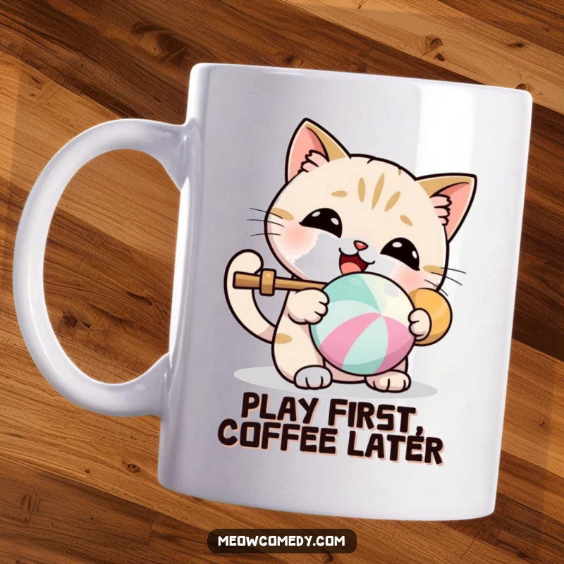 Funny kawaii mug showing a cute cat gleefully batting a colorful ball, radiating happiness and playfulness.