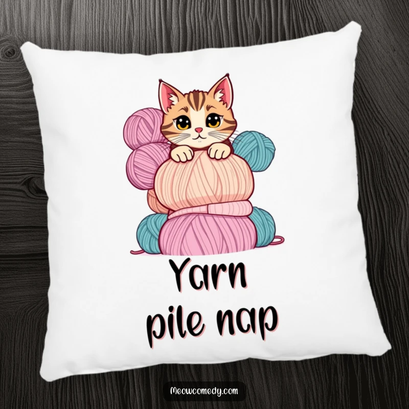 Funny cat pillow showing a mischievous cat peeking over a tall stack of colorful yarn balls with a playful glance.