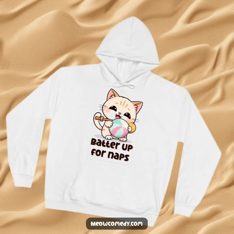 Funny hoodie with a kawaii cat joyfully batting a colorful ball, offering cozy and cute humor.