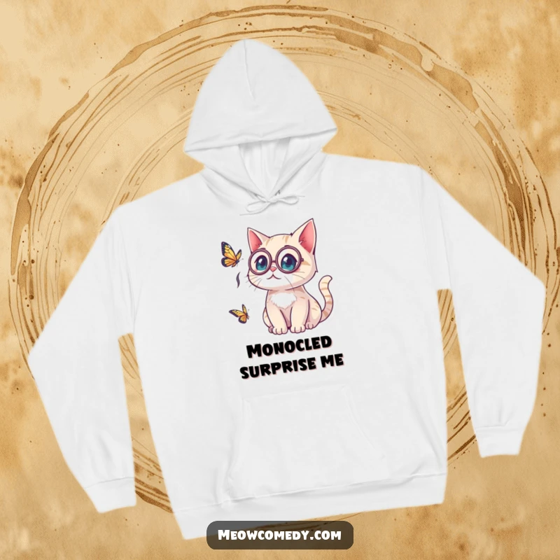 Funny kawaii cat wearing a monocle, looking surprised by a butterfly, a cozy and amusing scene on a comfortable hoodie.