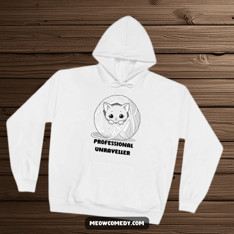Funny kawaii cat peeking from behind a giant ball of yarn, comfortable and humorous hoodie for cozy cat fans.