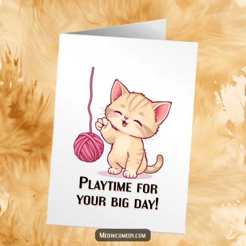 Funny free printable birthday card showing a playful kitten happily batting at a colorful ball of yarn.
