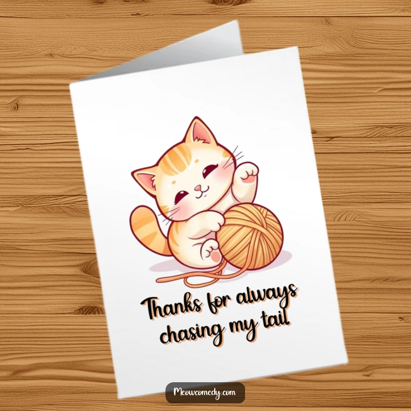 Charming Free Printable Thank You Card of a playful cat blissfully tumbling amidst a mess of colorful yarn, showing happy thanks.