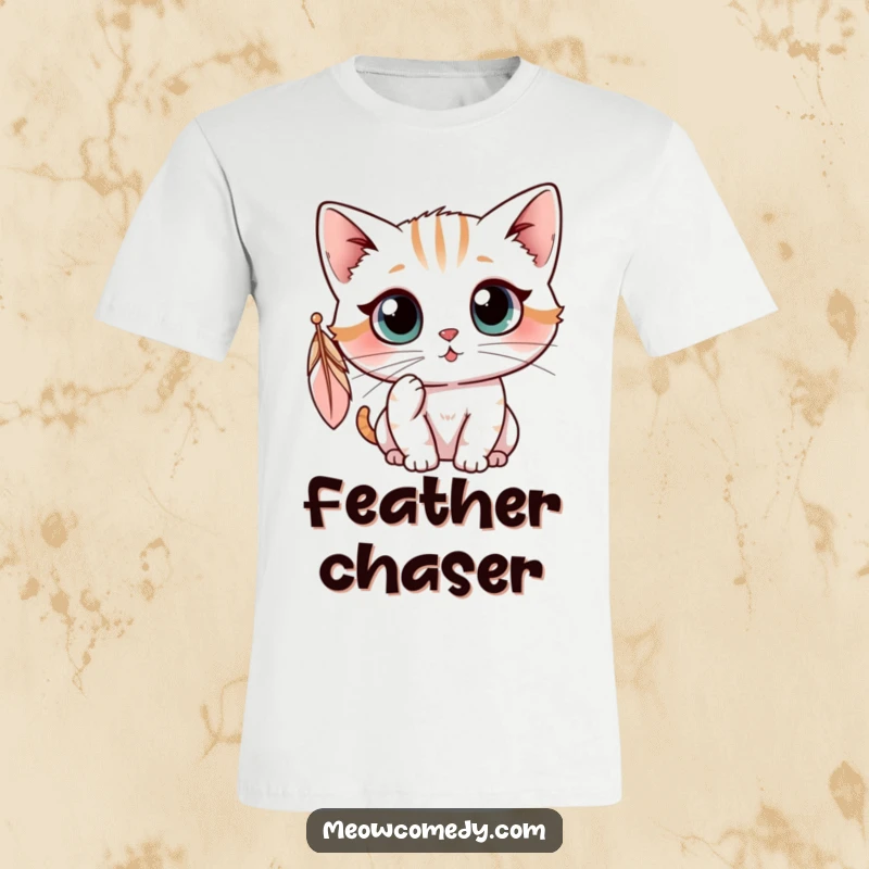 Funny kawaii cat with wide, curious eyes batting at a dangling feather, humorous and cute playtime t-shirt.