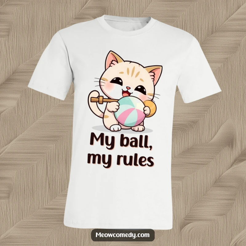 Funny t-shirt featuring a kawaii cat delightfully batting a vibrant, colorful ball.