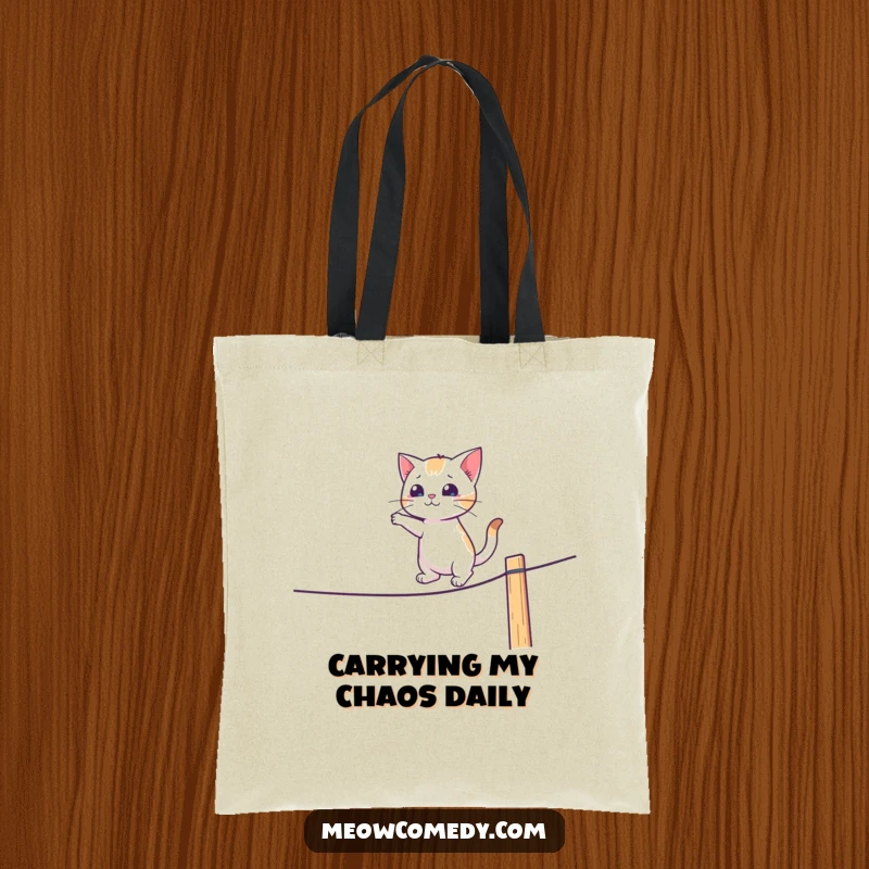 Funny tote bag showing a cat attempting a difficult tightrope walk on a fence with comedic effect.