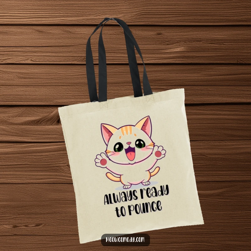 Funny tote bag featuring a cat performing an excited, playful pounce with its front paws extended.
