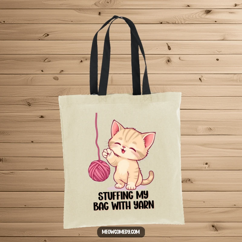 Funny Playful Kitten Tote Bag: A cute kitten playfully bats at a dangling ball of yarn, perfect for a fun and functional tote.
